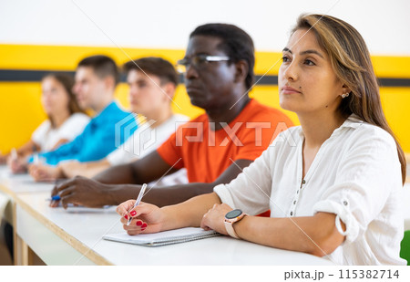 Woman with other students in studying with their colleagues 115382714