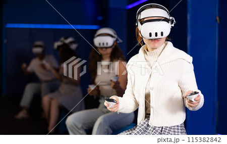 Girls using virtual reality glasses - girlfriends having fun with vr headset Girls using virtual reality glasses - girlfriends having fun with vr headset 115382842