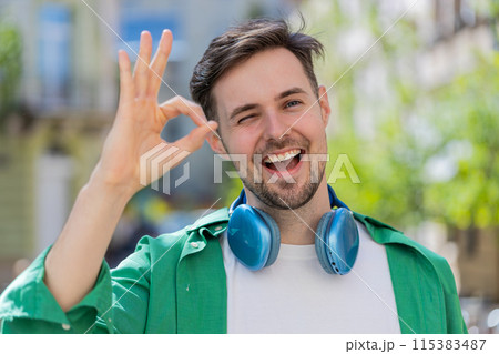 Caucasian man looking approvingly at camera showing OK gesture positive like sign Okay celebrate win Caucasian man looking approvingly at camera showing OK gesture positive like sign Okay celebrate win 115383487