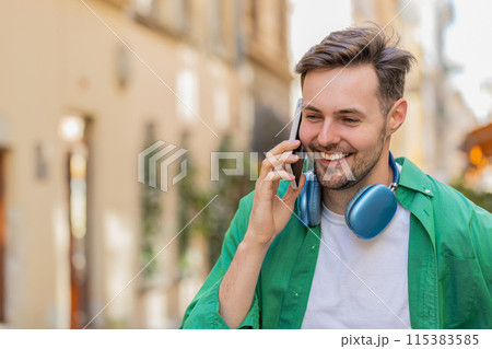 Man tourist having remote conversation communicate speaking by smartphone with friend good news Man tourist having remote conversation communicate speaking by smartphone with friend good news 115383585