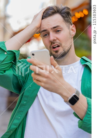 Sad man using smartphone browsing loses lottery casino application results bad news fail virus Sad man using smartphone browsing loses lottery casino application results bad news fail virus 115383603
