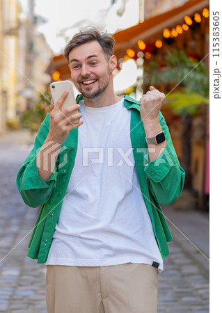 Happy man using mobile smartphone celebrating win good message news, lottery casino jackpot victory Happy man using mobile smartphone celebrating win good message news, lottery casino jackpot victory 115383605