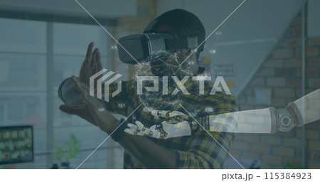 Image of globe of connections over robot's arm and man wearing vr headset in background Image of globe of connections over robot's arm and man wearing vr headset in background 115384923