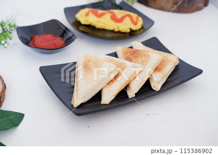 delicious toast and omelet as a background delicious toast and omelet as a background 115386902