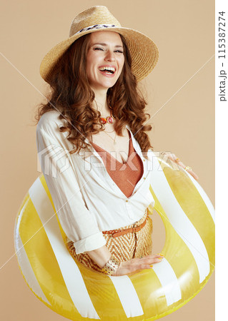 smiling woman in blouse and shorts isolated on beige smiling woman in blouse and shorts isolated on beige 115387274