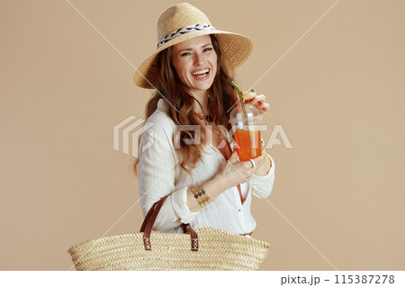 smiling trendy woman in blouse and shorts isolated on beige smiling trendy woman in blouse and shorts isolated on beige 115387278