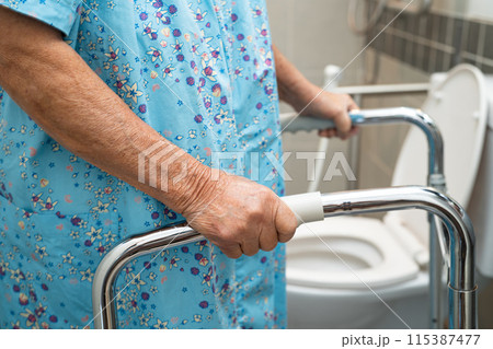 Asian elderly woman patient use walker and toilet bathroom handle security in nursing hospital, healthy strong medical. 115387477