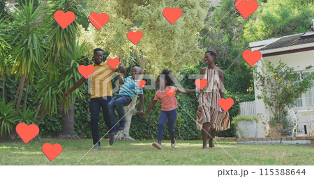Image of hearts over happy african american family in garden 115388644