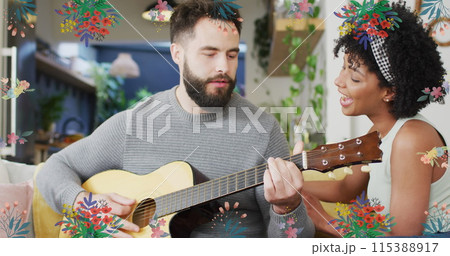 Image of flowers over happy diverse couple playing guitar together Image of flowers over happy diverse couple playing guitar together 115388917