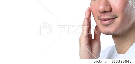 Man touching his face on white background with copy space. Skin care and beauty treatment concept 115389846