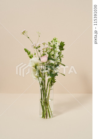 Flowers full of greenery in clear glass bottles 115391030