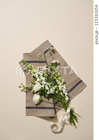 a bundle of fresh green leaves on a cloth 115391054