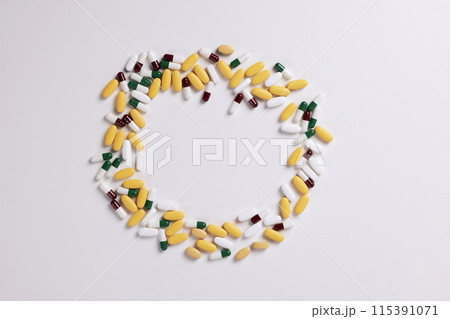 various pills arranged in a circular shape 115391071