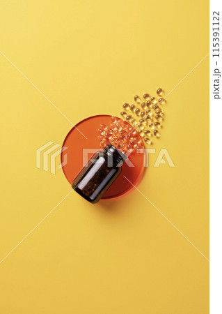 the yellow pills pouring out of the vat 115391122