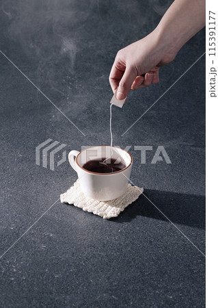 making a flower tea bag in a teacup making a flower tea bag in a teacup 115391177