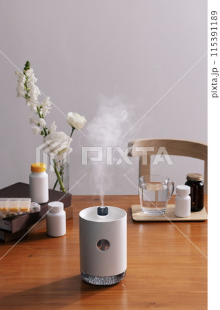 Spray from the humidifier on the table Spray from the humidifier on the table 115391189