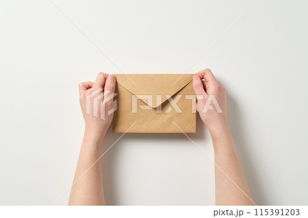 holding the envelope with both hands holding the envelope with both hands 115391203