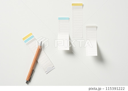 several notepads and pens 115391222