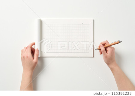 a hand to write on a manuscript 115391223