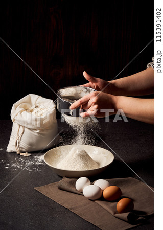 The process of sifting flour with both hands 115391402