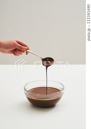 a spoonful of melted chocolate a spoonful of melted chocolate 115391490