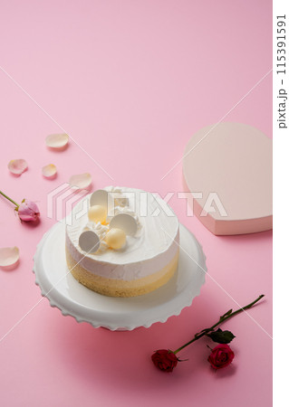 a white cake on a cake stand 115391591