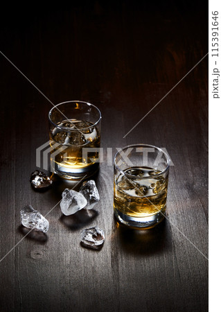 a glass of lemon and ice and a cigar 115391646