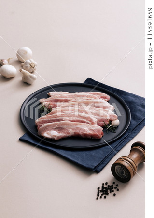 fresh pork belly piled on wooden chopping boards 115391659