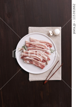 fresh pork belly piled on wooden chopping boards 115391662