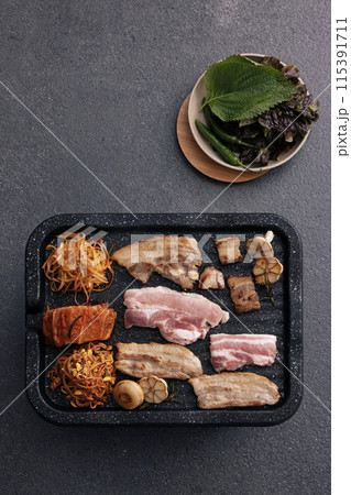Grilled pork belly with vegetables and side dishes on the grill Grilled pork belly with vegetables and side dishes on the grill 115391711