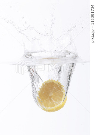 half of a lemon falling into the water 115391734