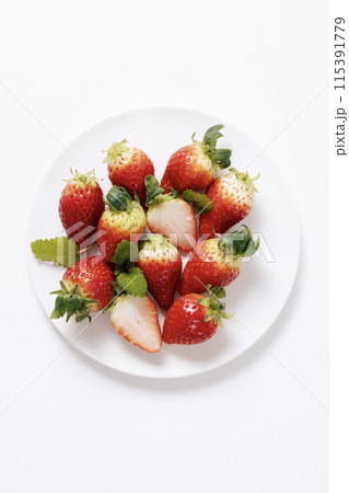 a pile of strawberries in a plate 115391779