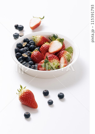 Blueberries and strawberries on a white plate 115391793