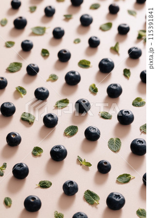 regular blueberries and green leaves regular blueberries and green leaves 115391841