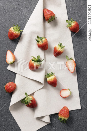 a fresh strawberry placed obliquely on a white cloth a fresh strawberry placed obliquely on a white cloth 115391901