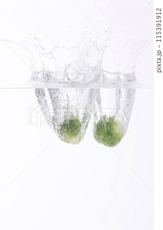 several cabbage falling into the water 115391912
