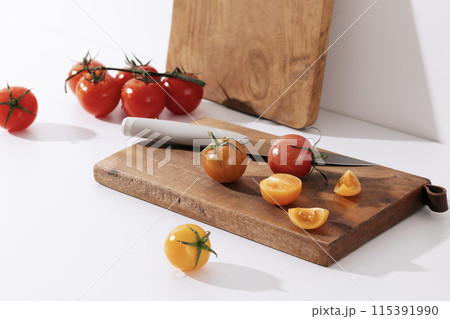 Fresh cherry tomatoes on wood chopping board 115391990