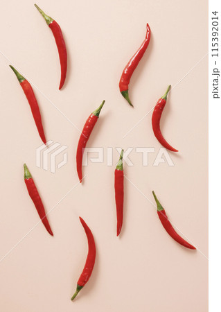 Red pepper arrangement with a light beige background 115392014