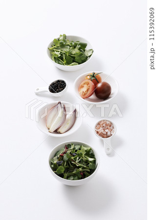 the composition of salad ingredients on a white plate the composition of salad ingredients on a white plate 115392069