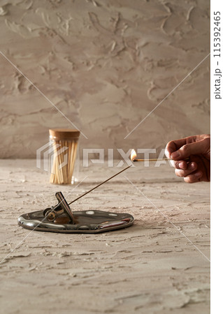 a match lighting insense stick a match lighting insense stick 115392465