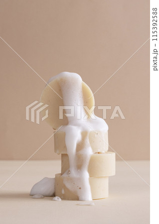 Beige soap and foam on the table 115392588