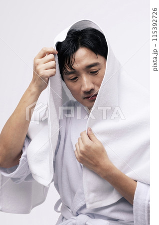 a middle aged man with a white towel around his head a middle aged man with a white towel around his head 115392726