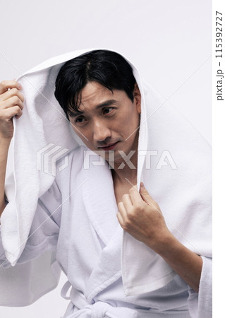 a middle aged man with a white towel around his head a middle aged man with a white towel around his head 115392727