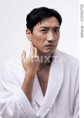 a middle aged man with a hand on his chin a middle aged man with a hand on his chin 115392732