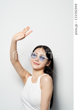 Asian Woman Posing in White Sleeveless 115392949