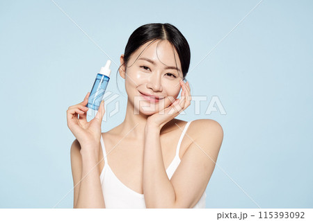 Asian woman posing with eye patches on both cheeks Asian woman posing with eye patches on both cheeks 115393092