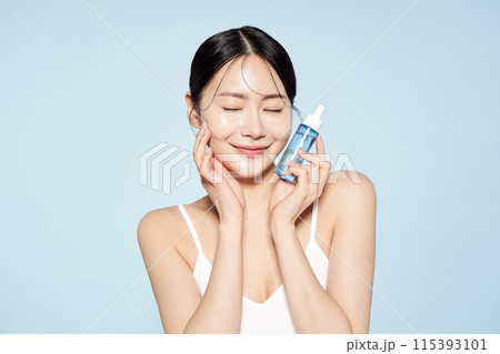 Asian woman posing with eye patches on both cheeks 115393101