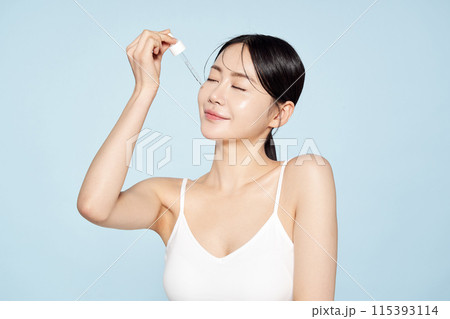 Asian Woman Drops Ampoule On Her Face With Spoid Asian Woman Drops Ampoule On Her Face With Spoid 115393114