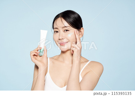 Asian Woman Poses With Cream Around Her Eyes Asian Woman Poses With Cream Around Her Eyes 115393135