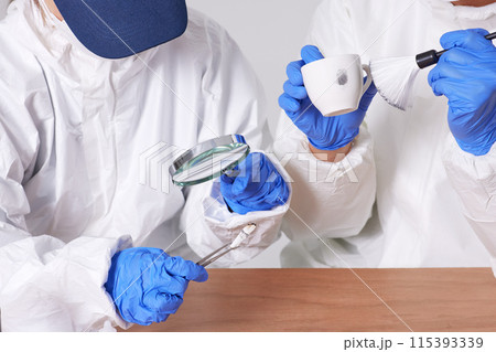 Researchers from the CSI Scientific Investigation Unit identifying evidence and collecting fingerprints at crime and incident sites 115393339